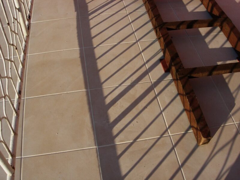 Wooden,Ladders,On,The,Terrace,Floor,And,Shadows,From,Metal